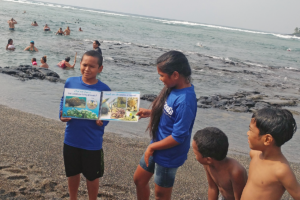 A youth leader practices teaching about the importance of coral in marine ecosystems