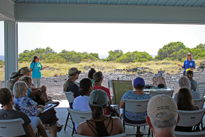 KBEC director Cindi Punihaole (left, in background) and Mimi Olry, DVM, demonstrate how to set up a Seal Protection Zone to a class of 40 new WHMMRN volunteers on April 9, 2015.